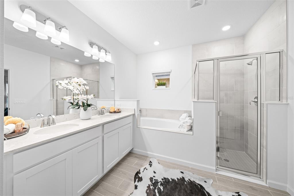 6880 Southwest 87th Street Ocala, FL 34476 - Photo 29 of 36 a bathroom with a double vanity sink mirror and shower