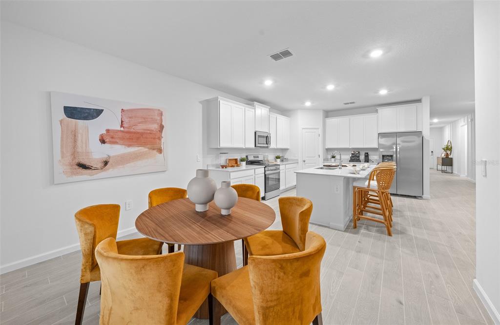 6880 Southwest 87th Street Ocala, FL 34476 - Photo 36 of 36 a kitchen with a dining table chairs and a refrigerator