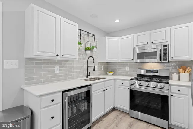a kitchen with a sink and a white cabinets
