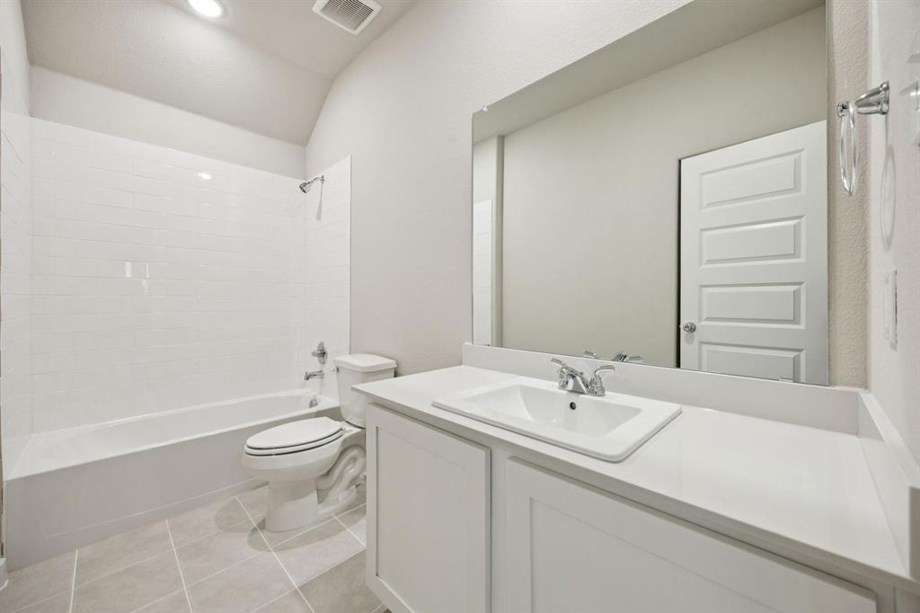 521 Sierra Ridge Lavon, TX 75166 - Photo 22 of 29 a bathroom with a sink a toilet and shower