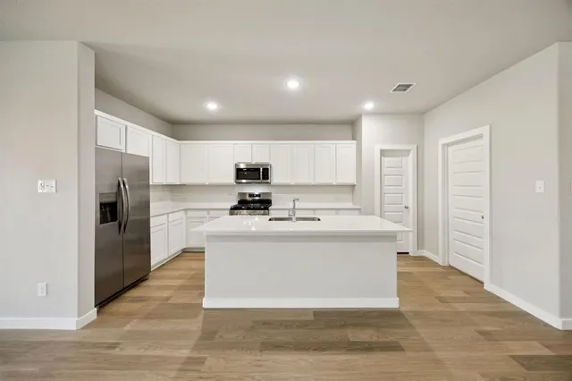 a view of kitchen with cabinets and stainless steel appliances