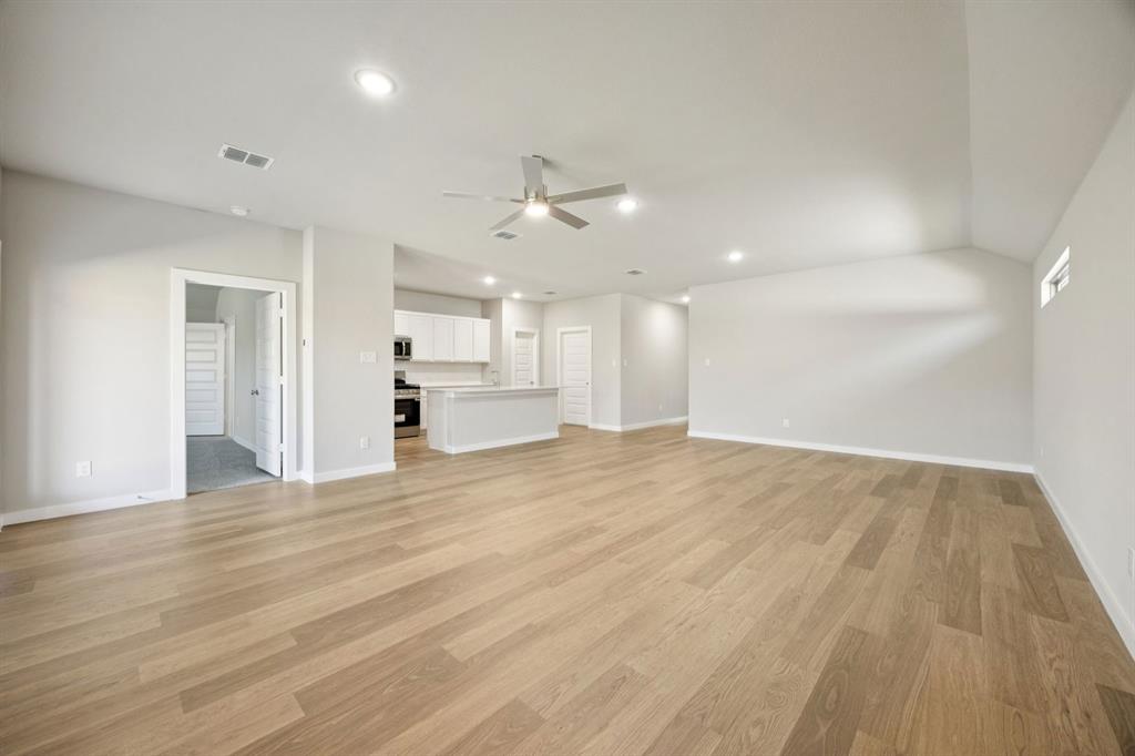521 Sierra Ridge Lavon, TX 75166 - Photo 29 of 29 a view of an empty room and kitchen view and wooden floor