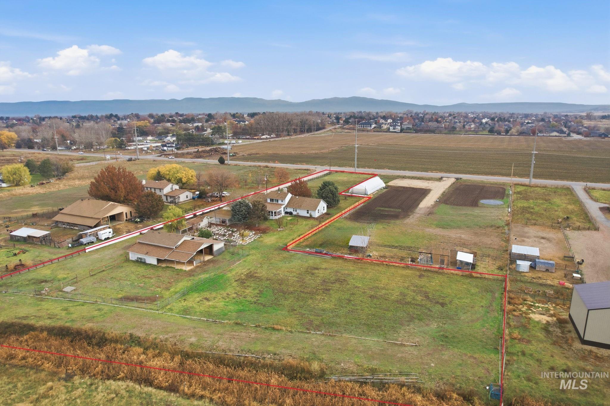 7985 South Cloverdale Road Boise, ID 83709 - Photo 3 of 49 Overview of rural landscape featuring property boundaries highlighted and a mountain backdrop