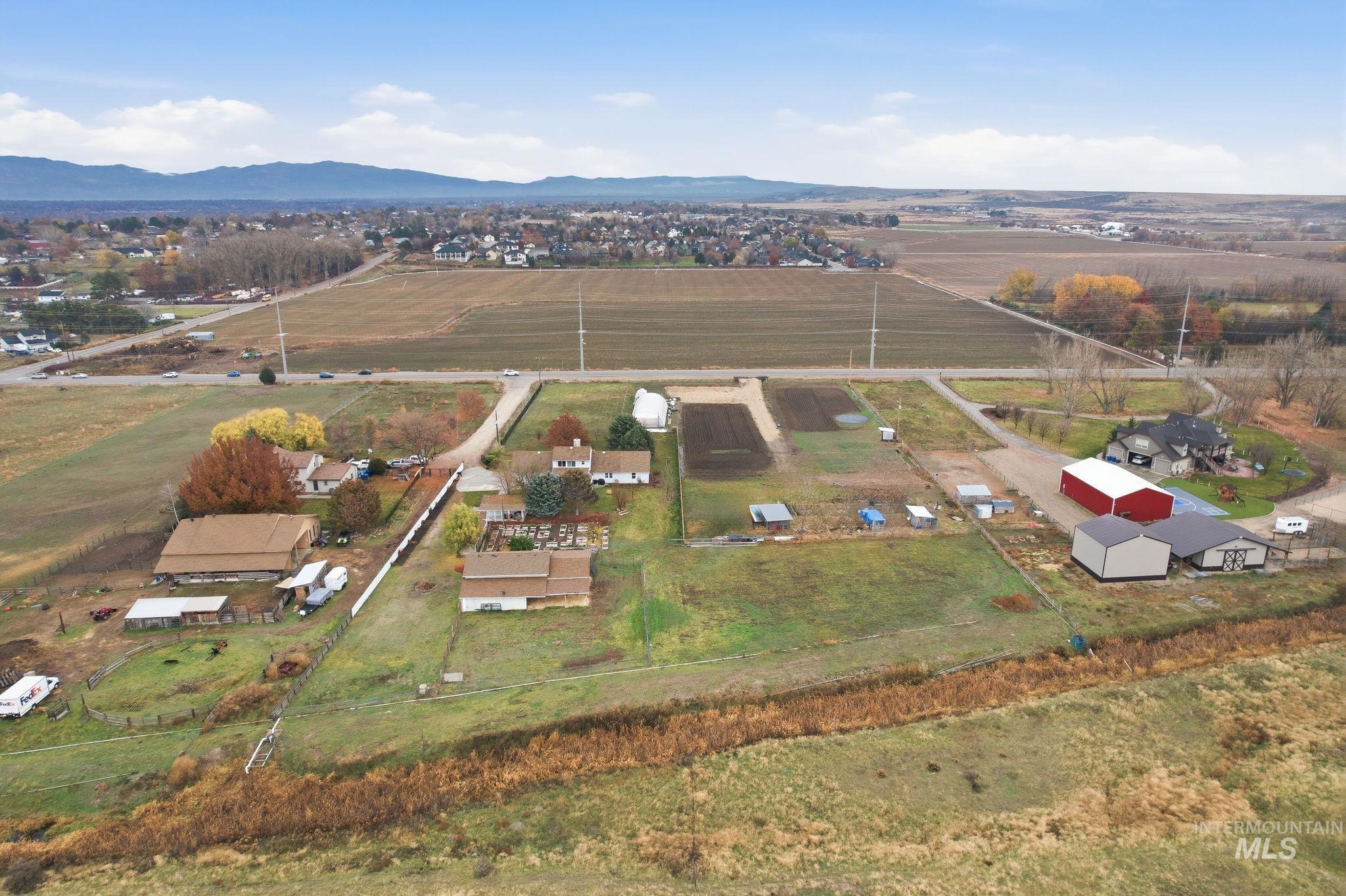 7985 South Cloverdale Road Boise, ID 83709 - Photo 47 of 49 Aerial view of property and surrounding area featuring rural landscape and mountains