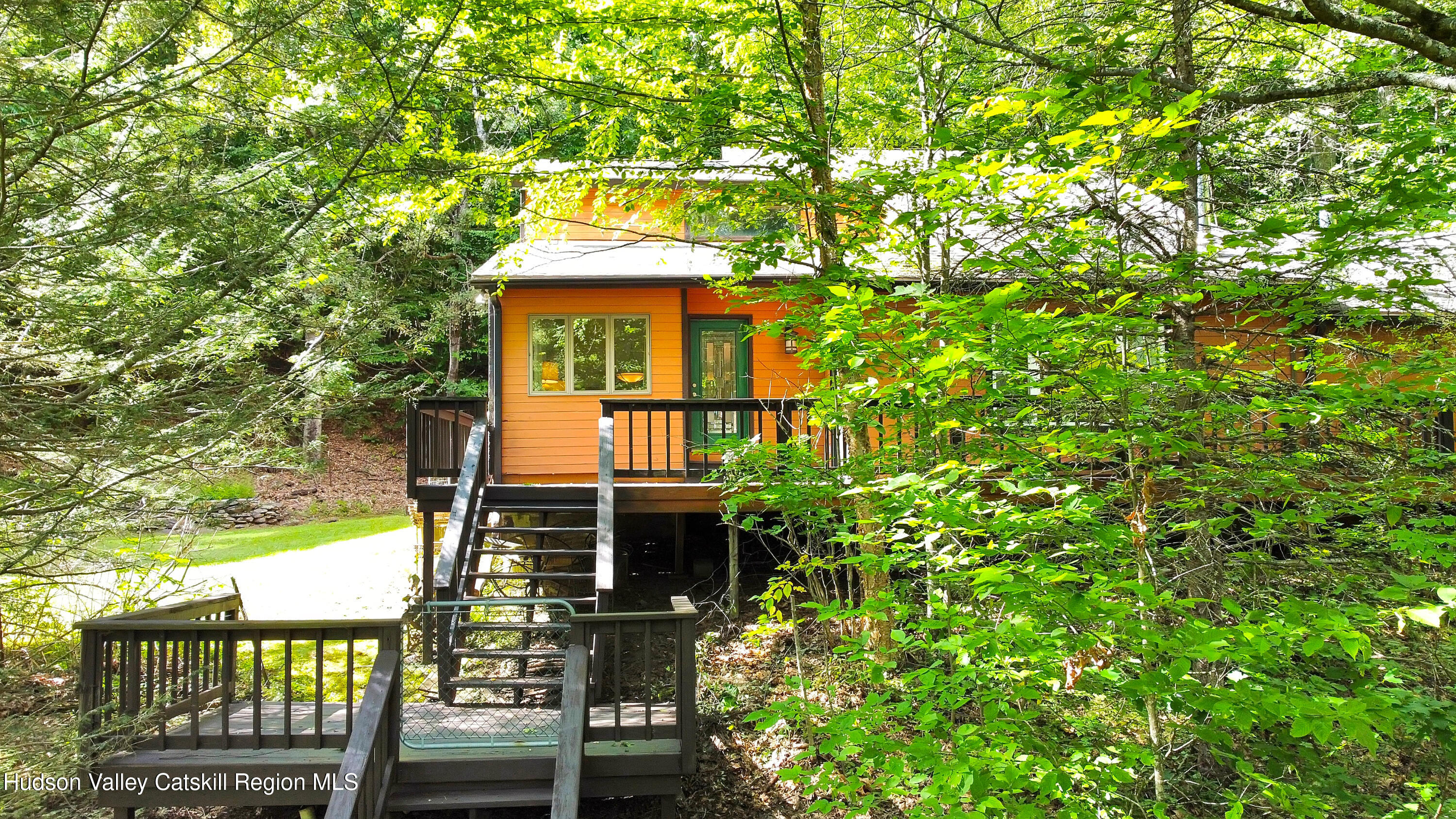 front view of a house with a tree