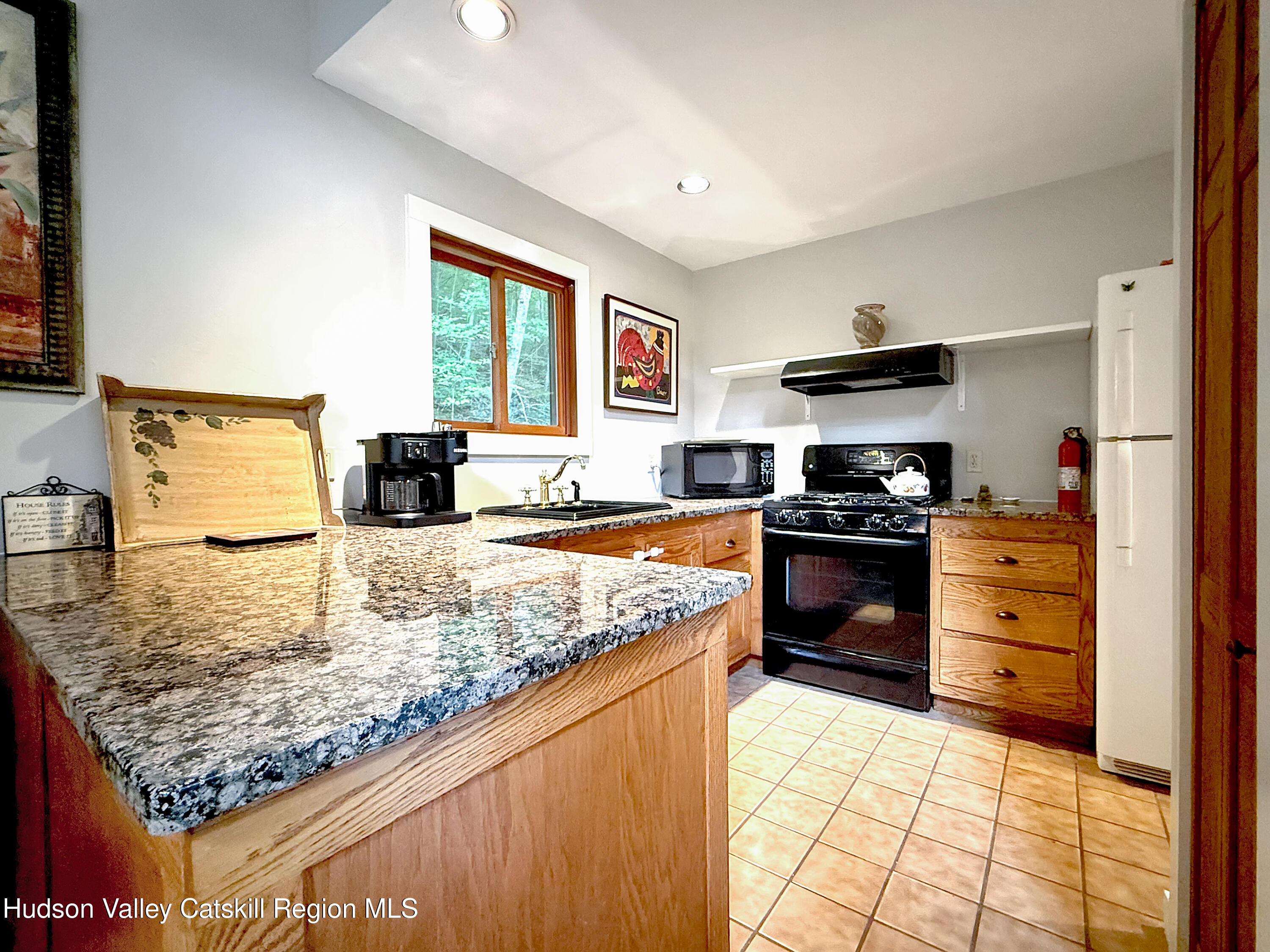 289 Red Falls Road Ashland, NY 12468 - Photo 21 of 44 a kitchen with a stove a sink and a refrigerator