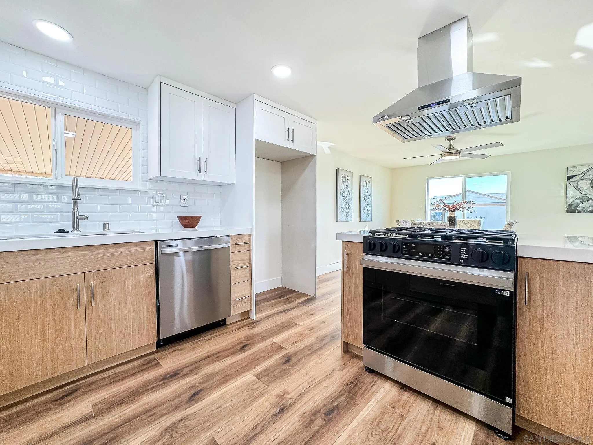 154 Falls View Lane Oceanside, CA 92056 - Photo 12 of 45 a kitchen with granite countertop white cabinets stainless steel appliances and window