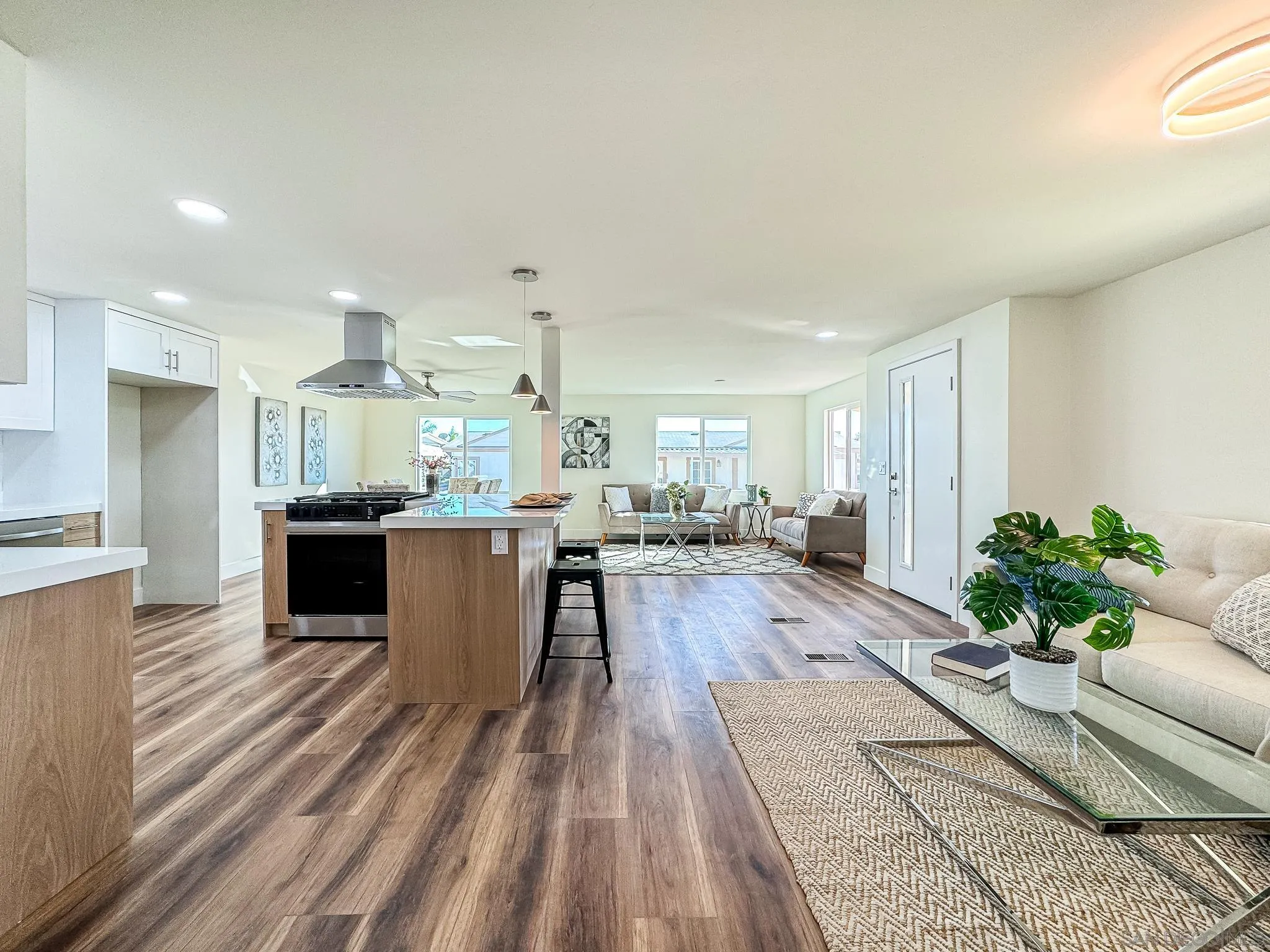 154 Falls View Lane Oceanside, CA 92056 - Photo 16 of 45 a view of a kitchen with kitchen island stainless steel appliances sink stove and living room view