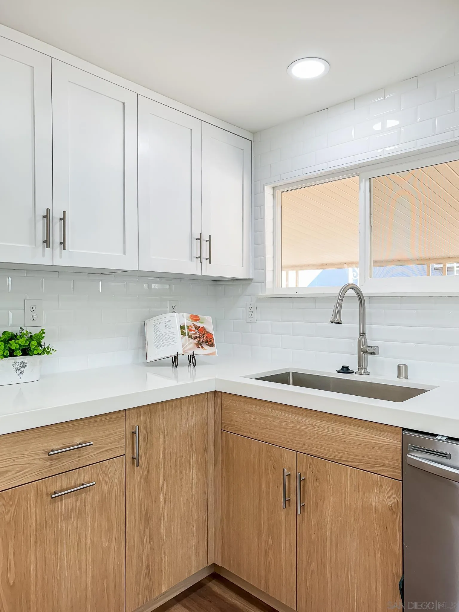 154 Falls View Lane Oceanside, CA 92056 - Photo 17 of 45 a kitchen with a sink cabinets and window