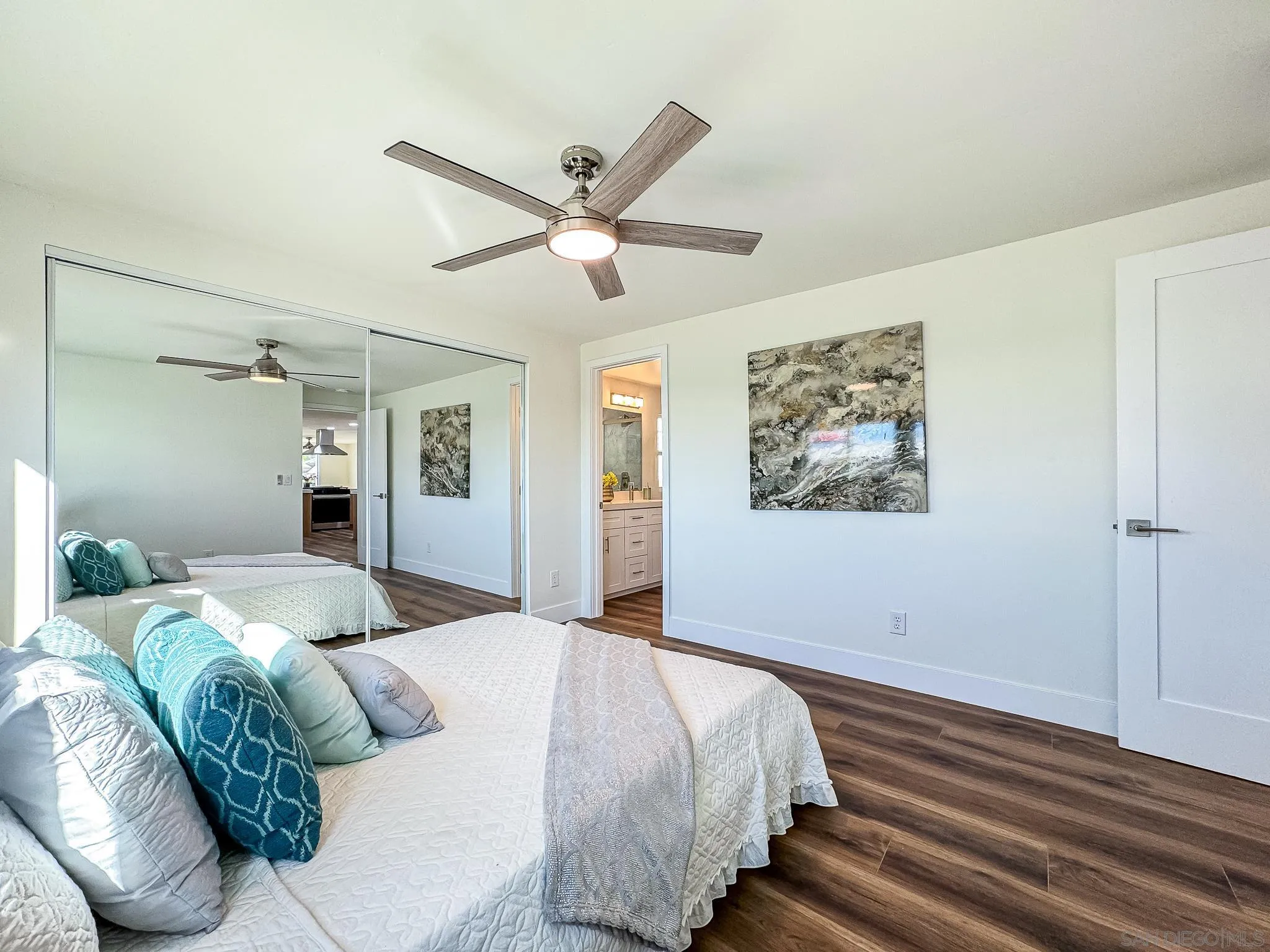 154 Falls View Lane Oceanside, CA 92056 - Photo 19 of 45 a bedroom with a large bed and a chandelier