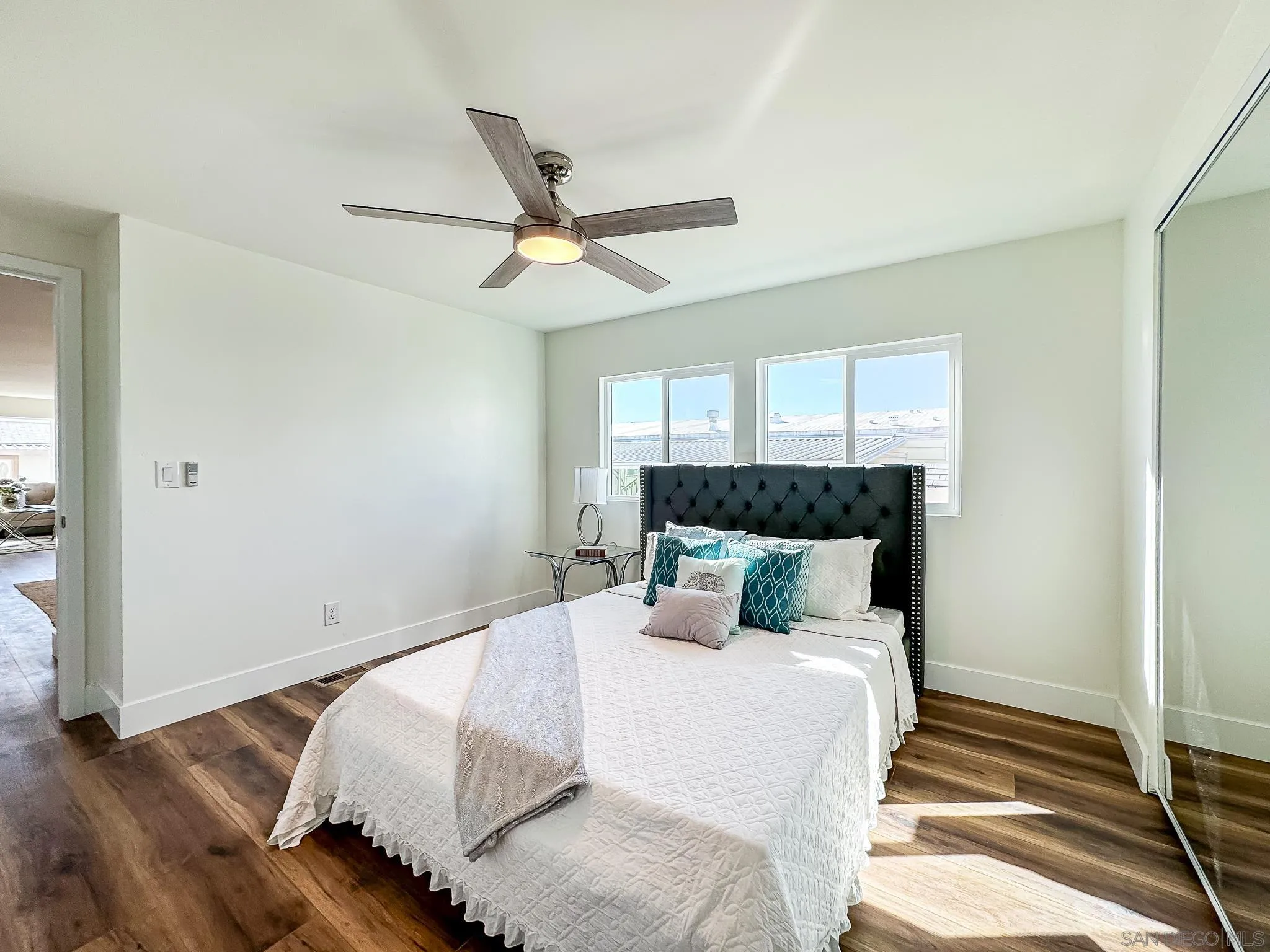 154 Falls View Lane Oceanside, CA 92056 - Photo 20 of 45 a bedroom with a bed and wooden floor