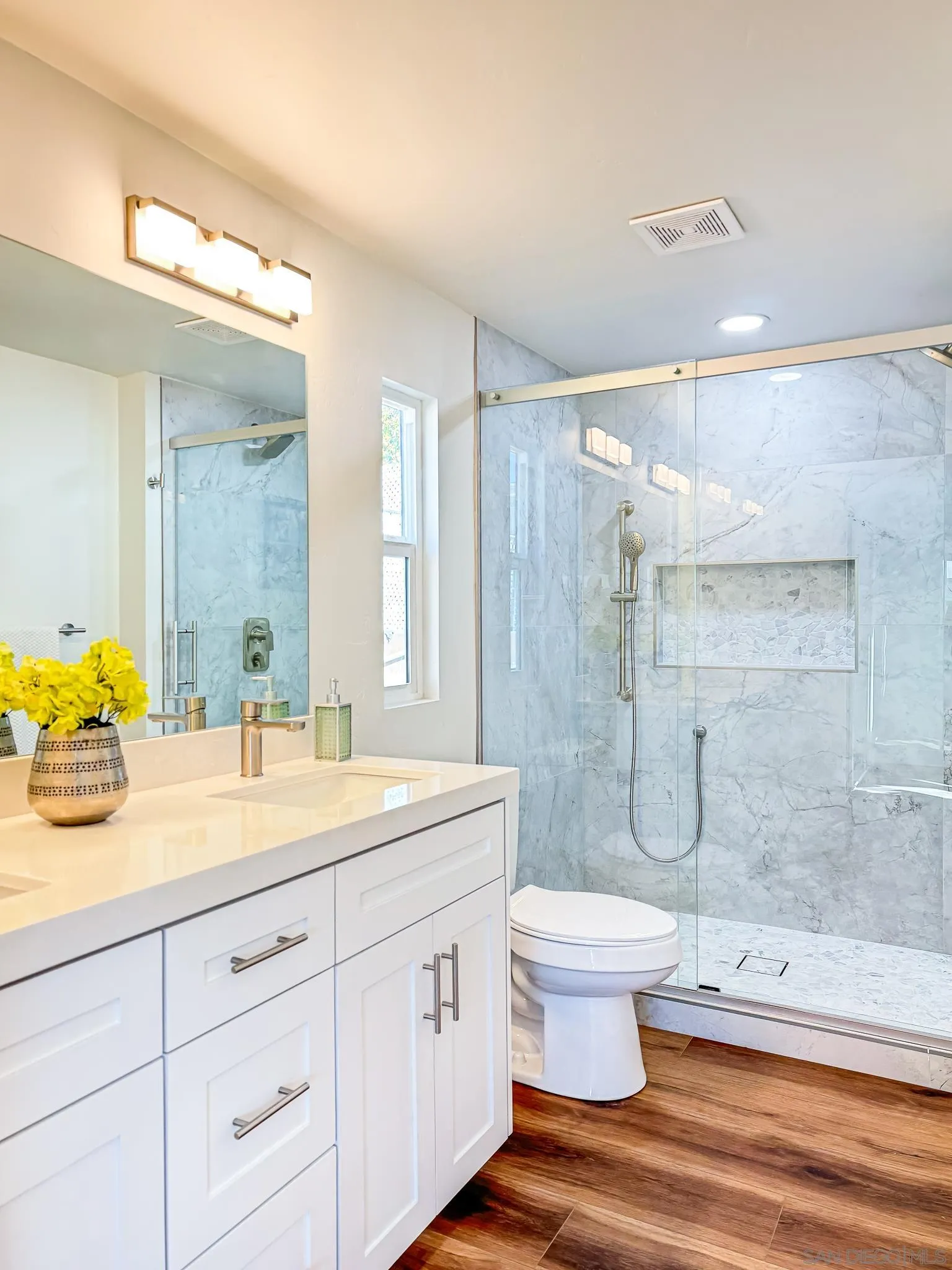 154 Falls View Lane Oceanside, CA 92056 - Photo 21 of 45 a bathroom with a double vanity sink toilet and shower