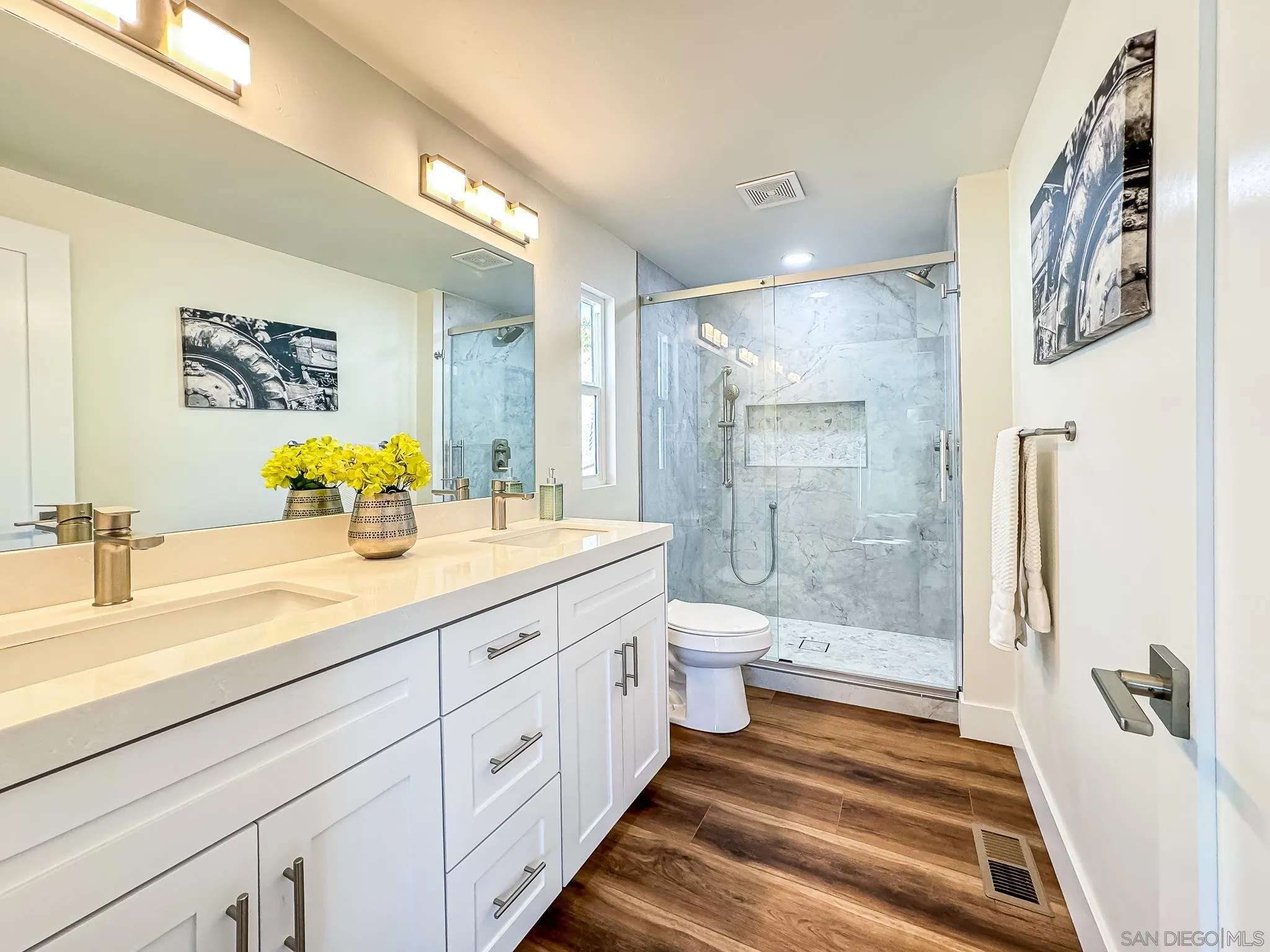 154 Falls View Lane Oceanside, CA 92056 - Photo 22 of 45 a spacious bathroom with a granite countertop sink and a mirror