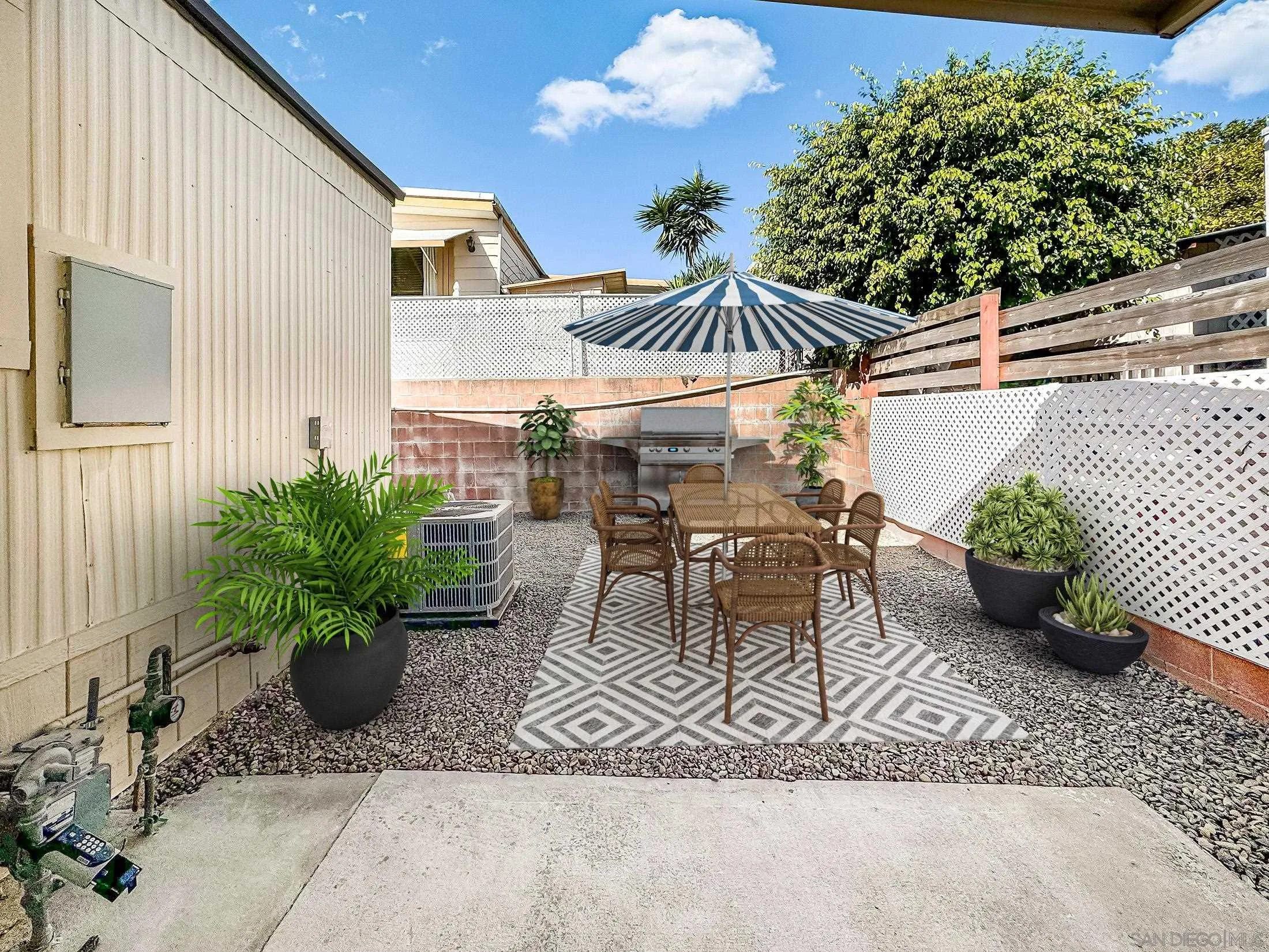 154 Falls View Lane Oceanside, CA 92056 - Photo 34 of 45 a view of a patio with table and chairs potted plants