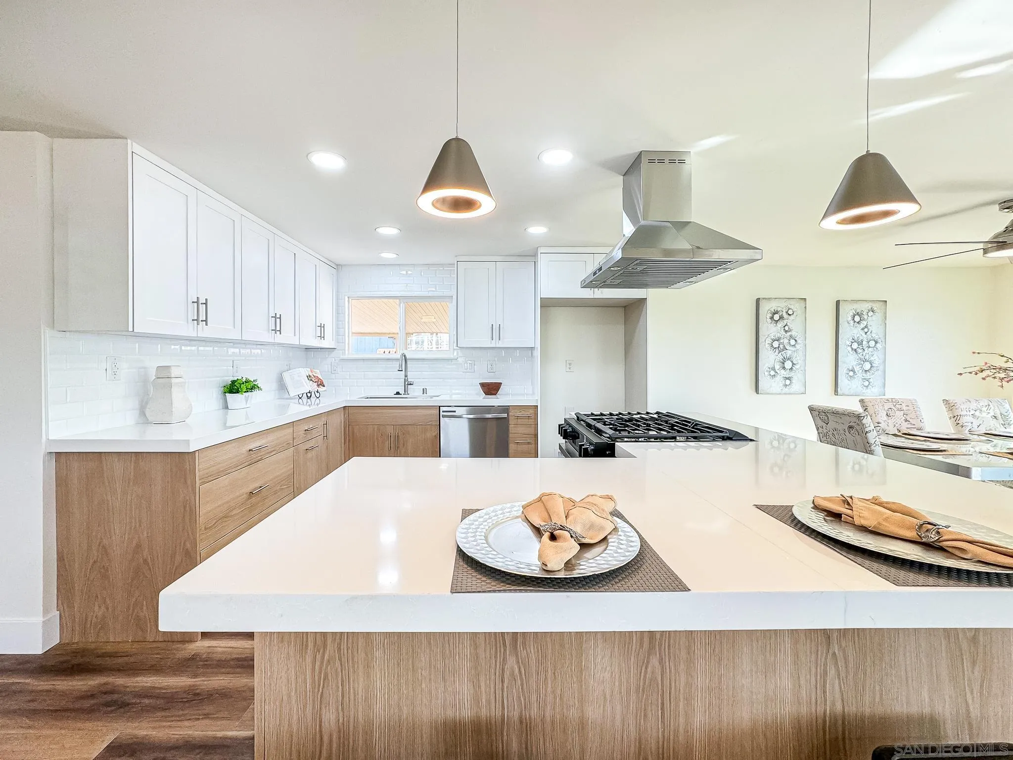 154 Falls View Lane Oceanside, CA 92056 - Photo 9 of 45 a kitchen with stainless steel appliances kitchen island granite countertop a table and chairs in it