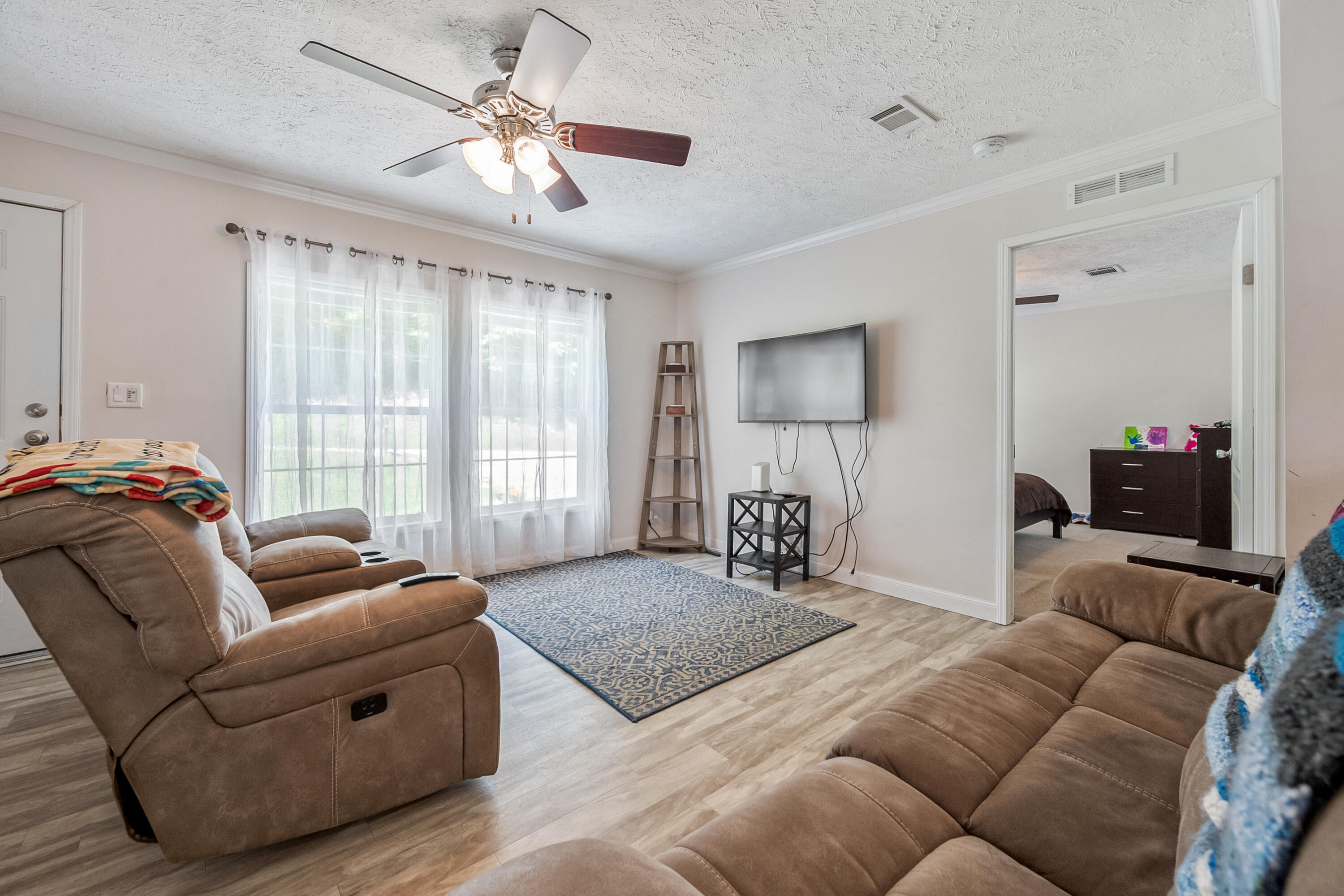 370 Ambrose Road Elliston, VA 24087 - Photo 9 of 63 a living room with furniture ceiling fan and a window