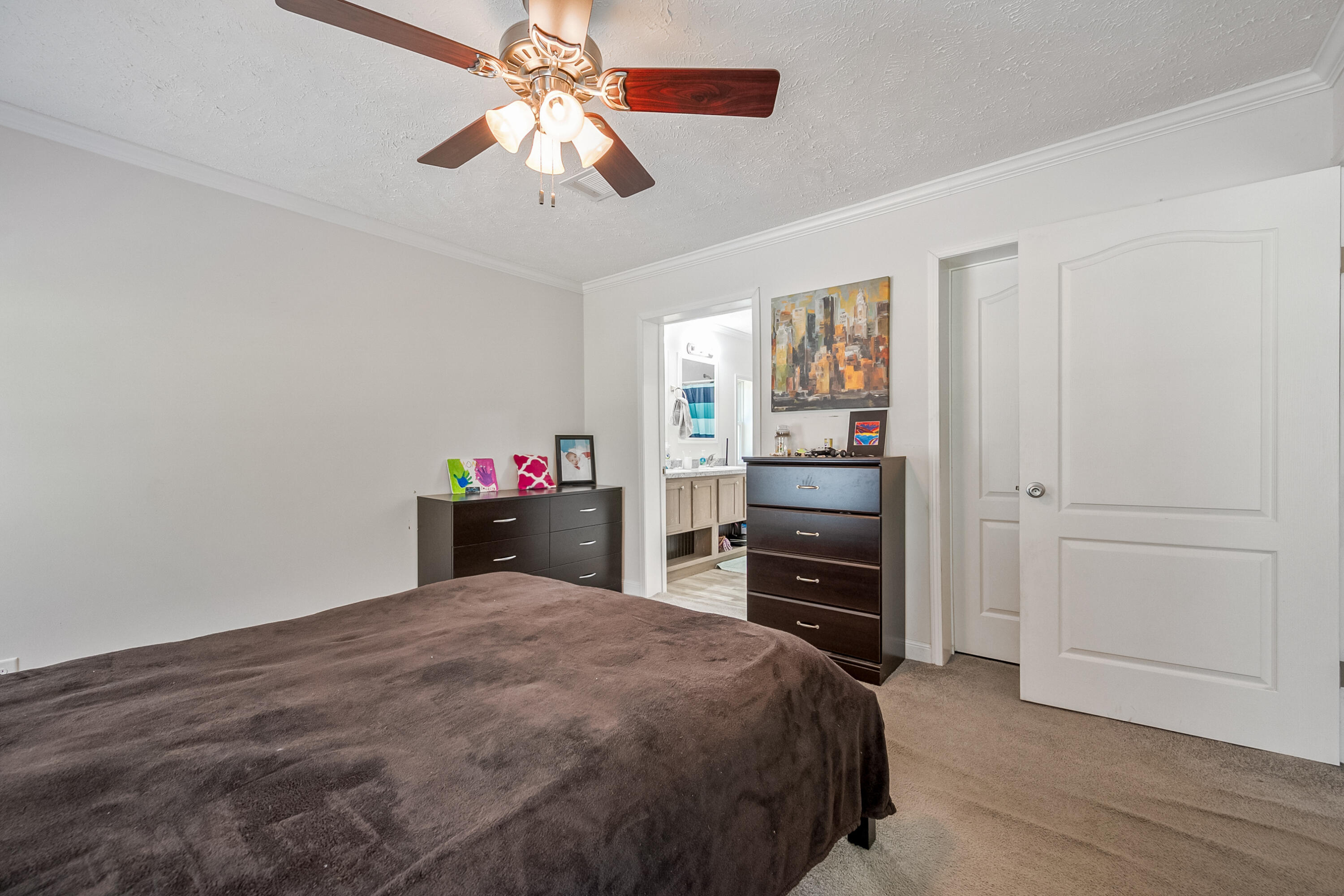 370 Ambrose Road Elliston, VA 24087 - Photo 13 of 63 a bedroom with a bed and a chandelier