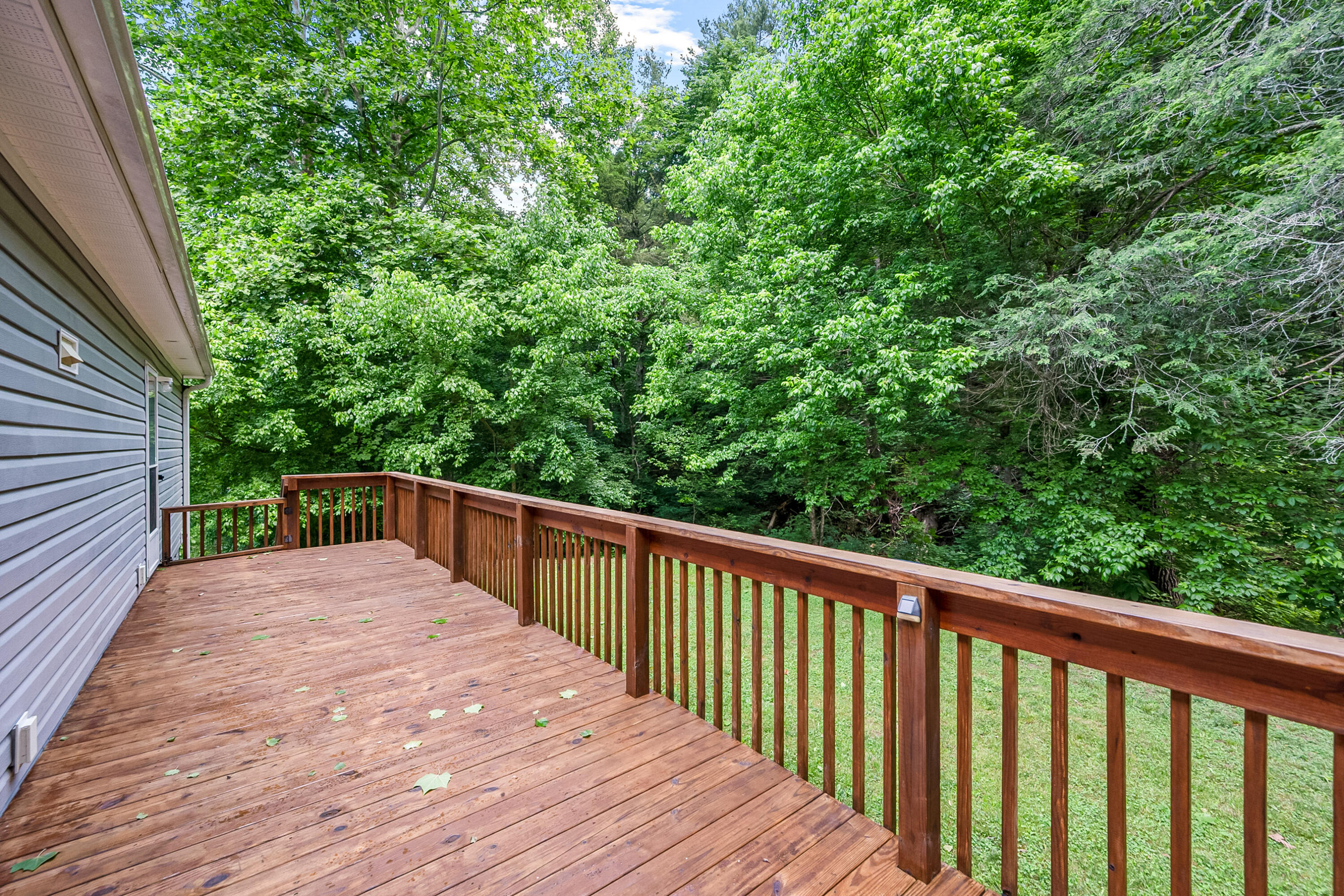 370 Ambrose Road Elliston, VA 24087 - Photo 46 of 63 a balcony with wooden floor and trees in the back