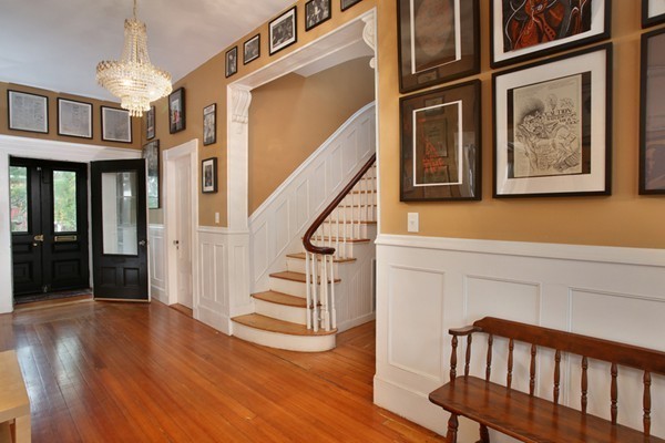 a view of entryway and hall with wooden floor
