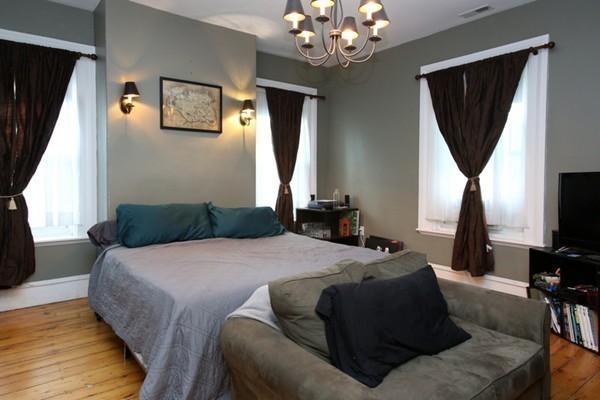 88 Lambert Avenue Boston, MA 02119 - Photo 13 of 19 a bedroom with a bed chandelier and a window