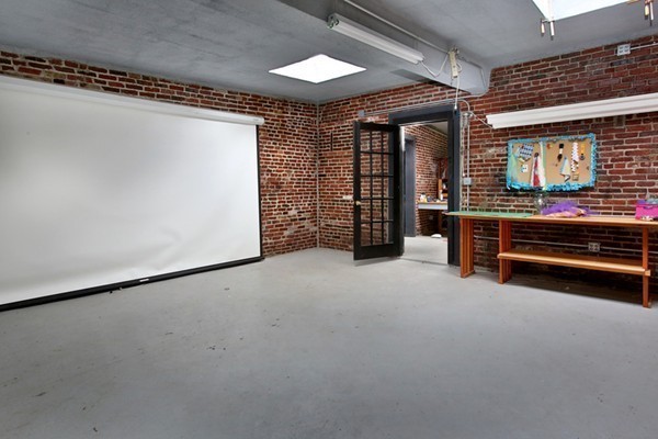88 Lambert Avenue Boston, MA 02119 - Photo 18 of 19 a view of an empty room with a fireplace