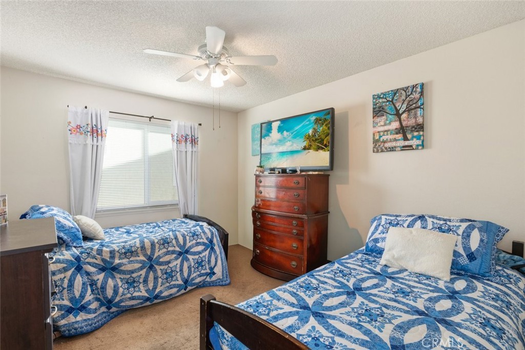 27262 Embassy Street Menifee, CA 92586 - Photo 20 of 35 a bedroom with a bed and furniture