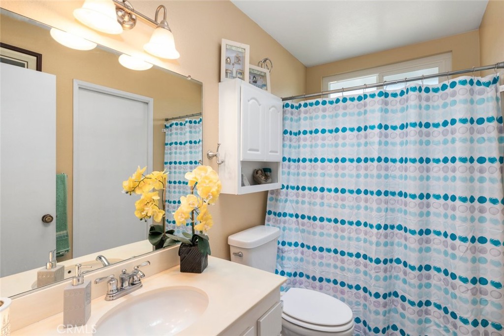 27262 Embassy Street Menifee, CA 92586 - Photo 21 of 35 a bathroom with a sink toilet and shower
