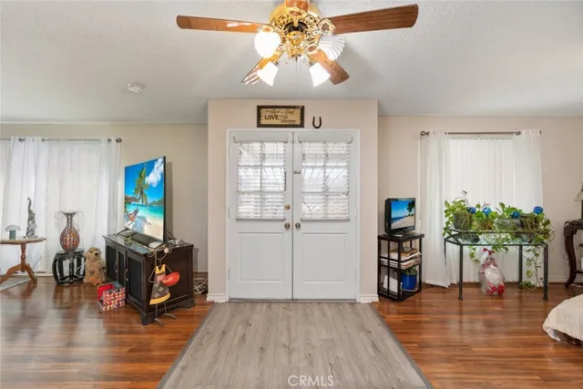 a living room with furniture and a wooden floor