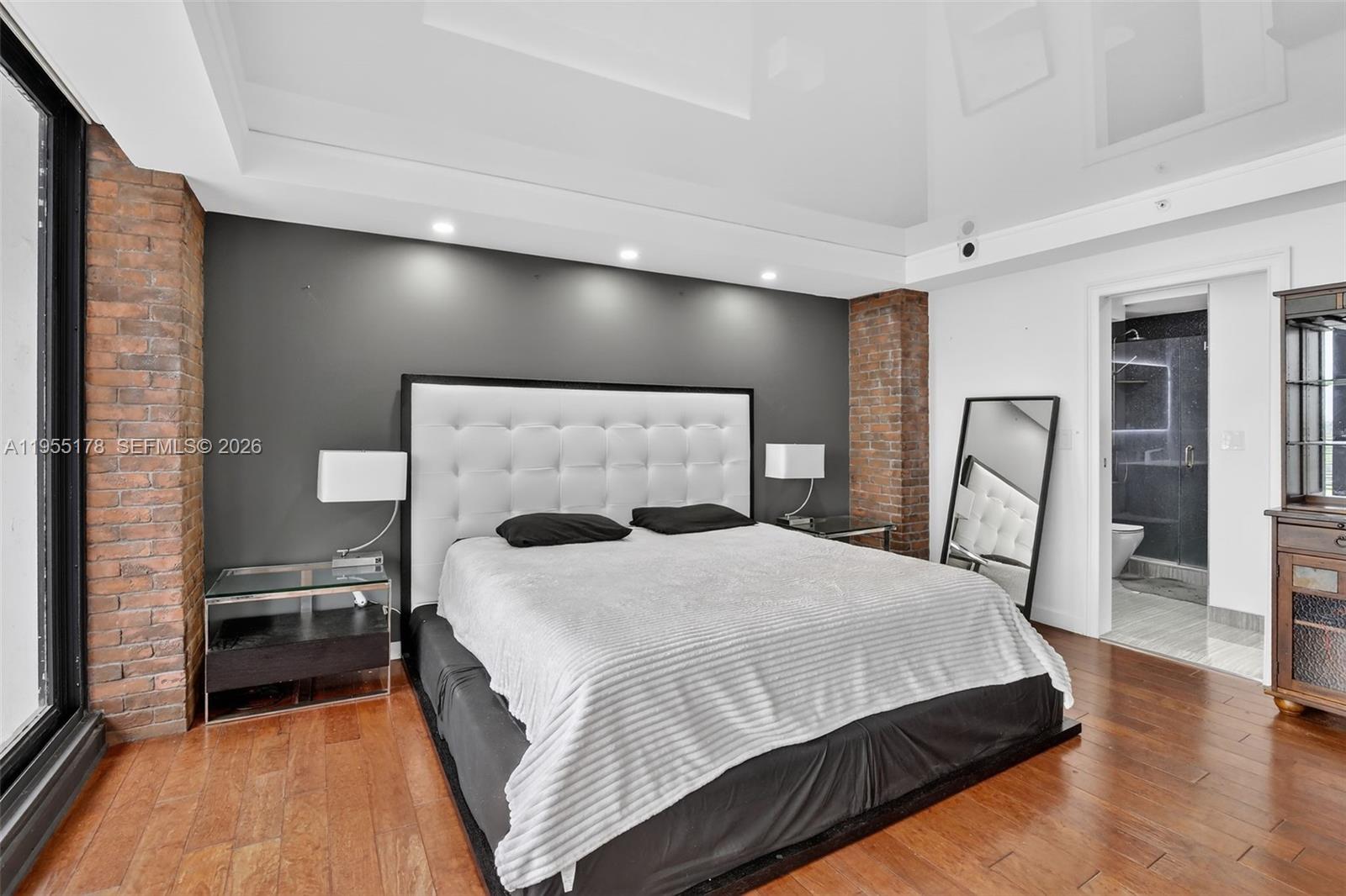 1720 Harrison Street, Unit 14H Hollywood, FL 33020 - Photo 13 of 37 a bedroom with a bed and a mirror