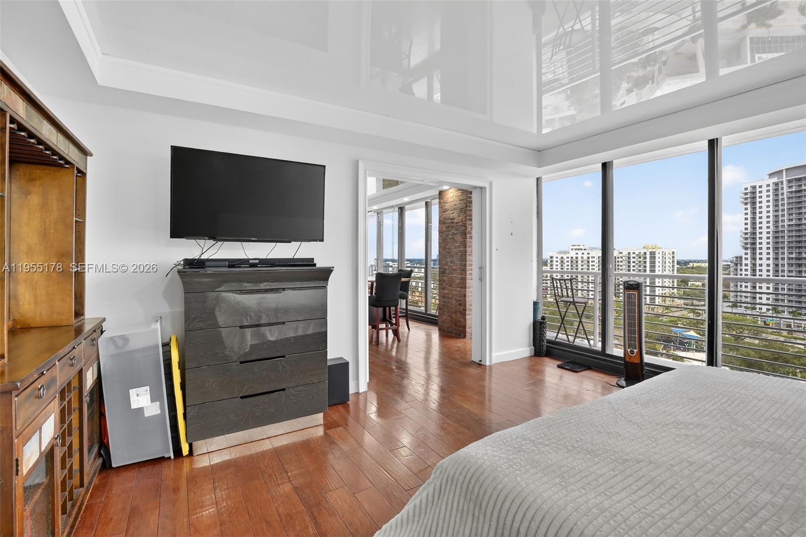 1720 Harrison Street, Unit 14H Hollywood, FL 33020 - Photo 17 of 37 a bedroom with furniture and a flat screen tv