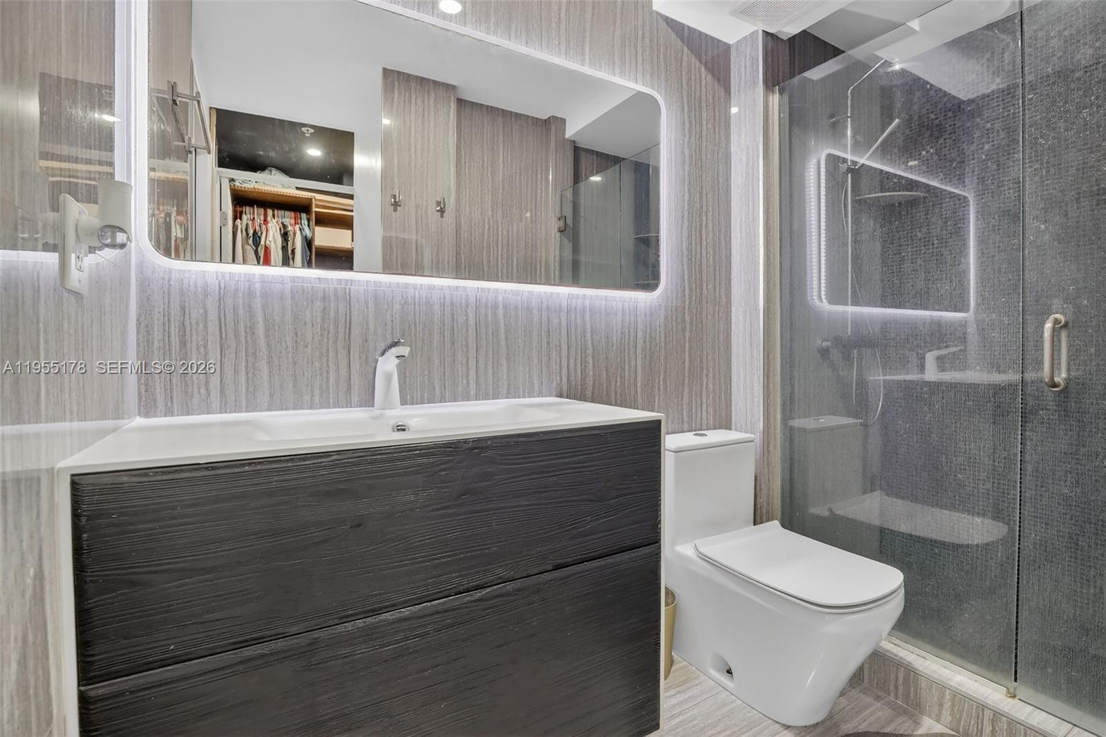 1720 Harrison Street, Unit 14H Hollywood, FL 33020 - Photo 19 of 37 a bathroom with a sink a toilet and shower