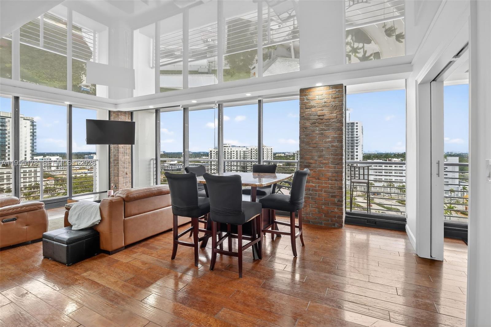 1720 Harrison Street, Unit 14H Hollywood, FL 33020 - Photo 2 of 37 a view of a dining room with furniture window and wooden floor