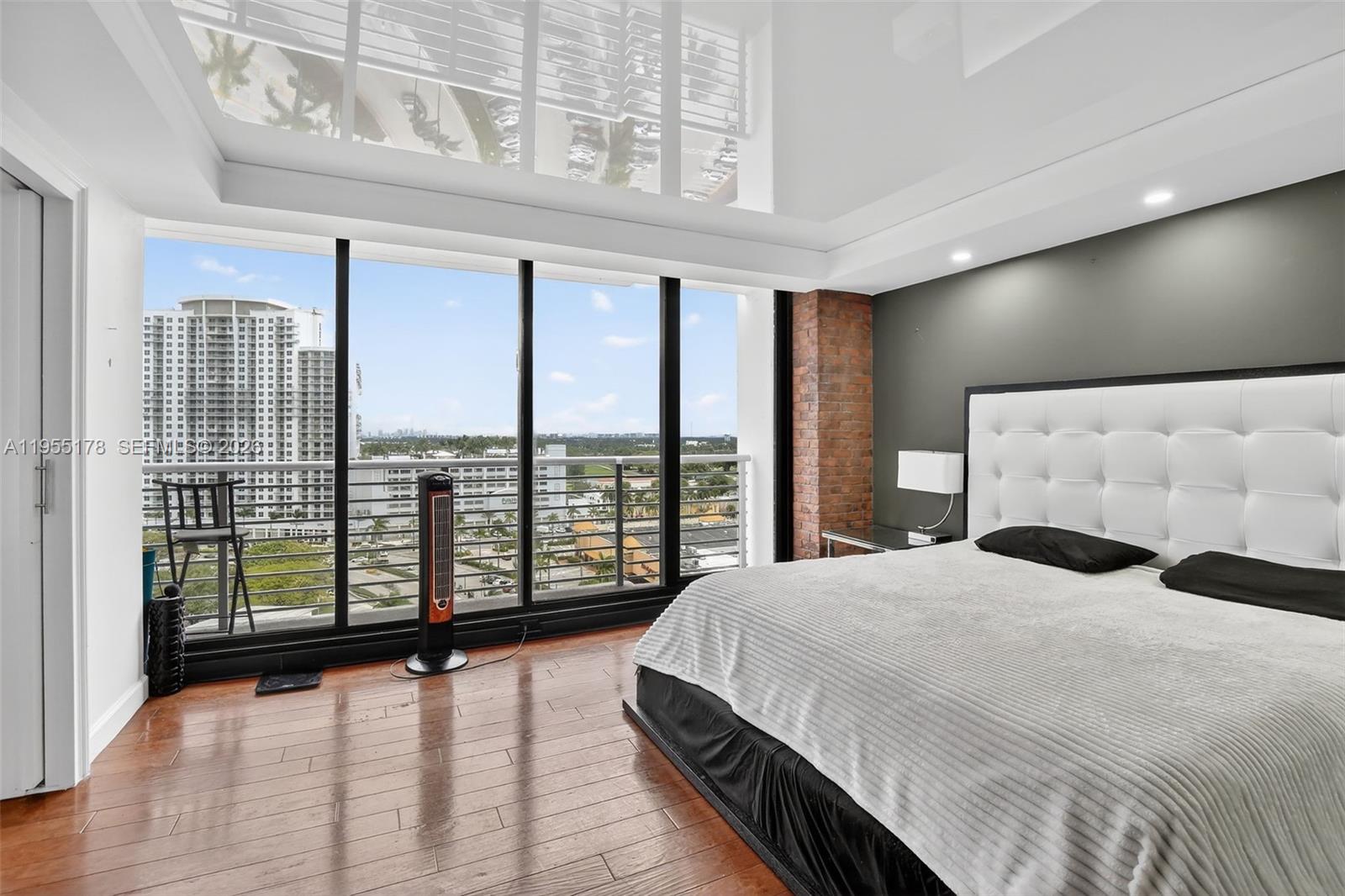 1720 Harrison Street, Unit 14H Hollywood, FL 33020 - Photo 4 of 37 a spacious bedroom with a large bed and a large window