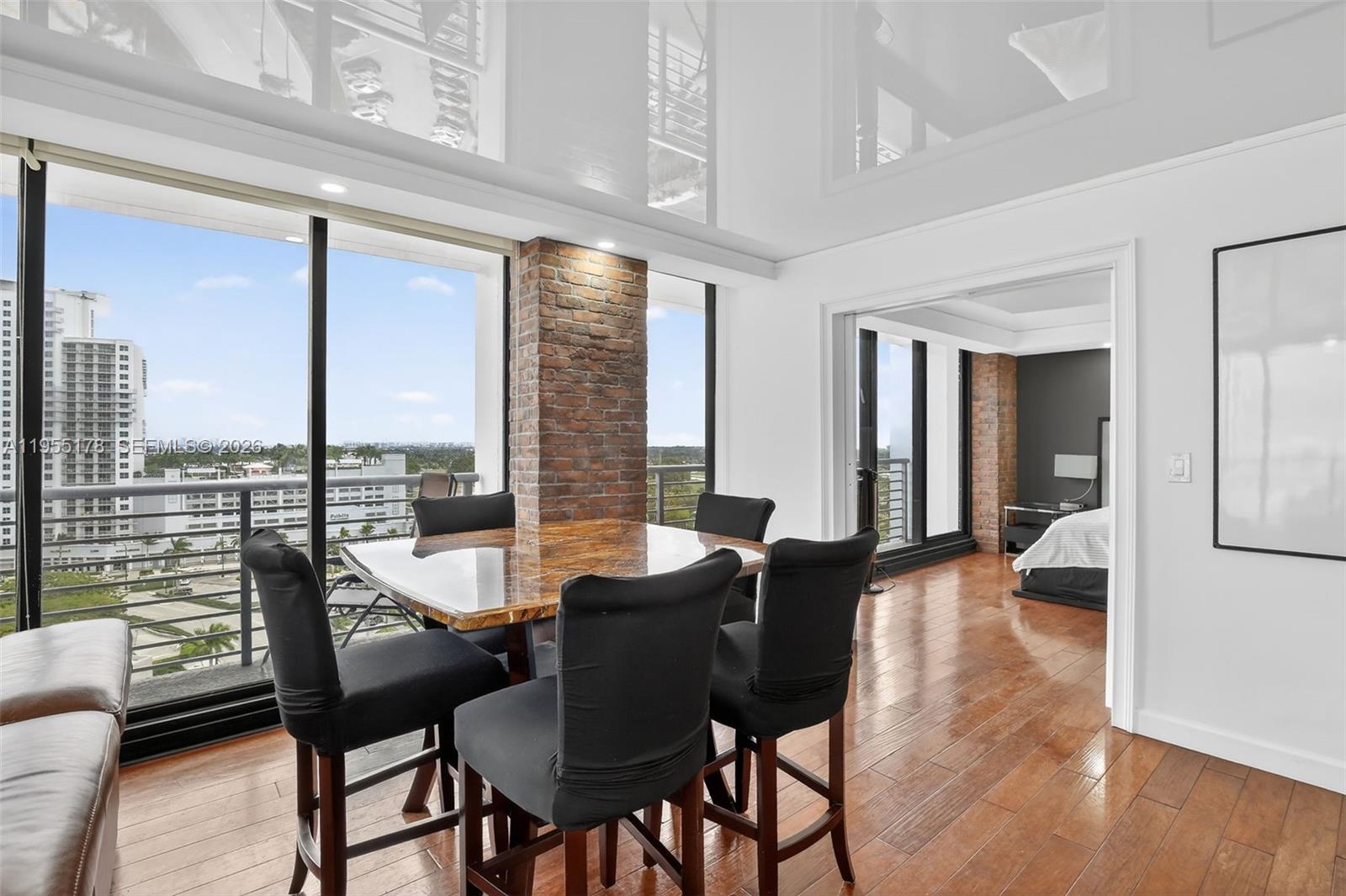 1720 Harrison Street, Unit 14H Hollywood, FL 33020 - Photo 6 of 37 a view of a dining room with furniture window and wooden floor