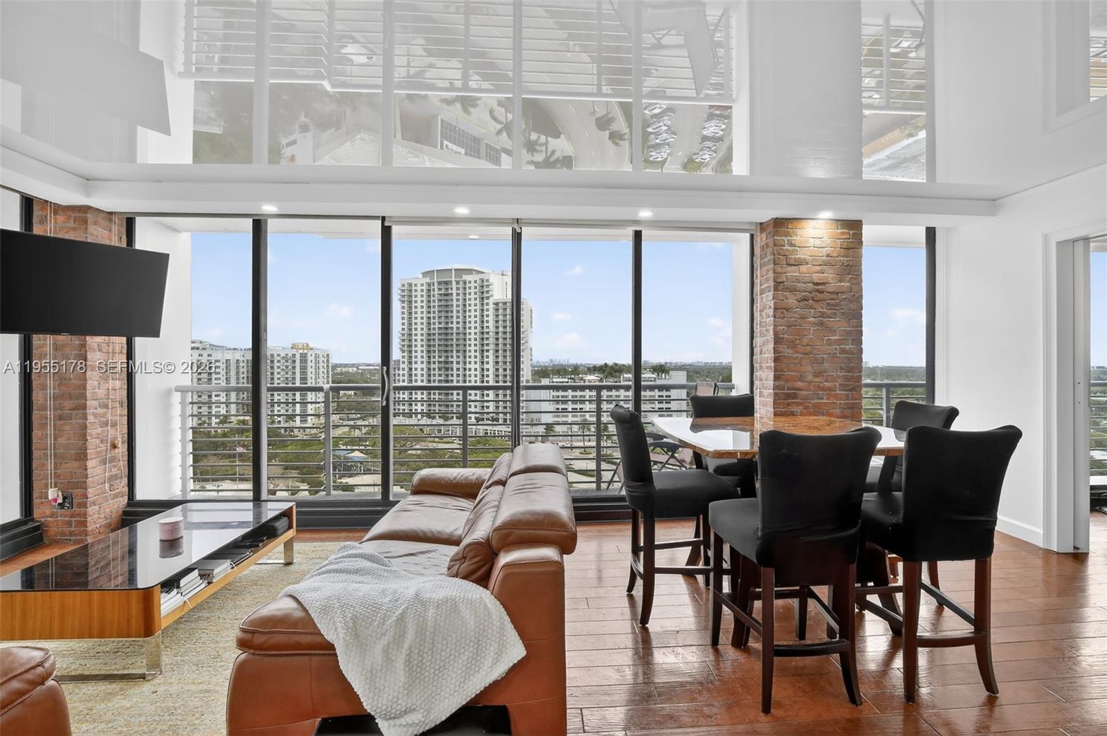 1720 Harrison Street, Unit 14H Hollywood, FL 33020 - Photo 7 of 37 a living room with furniture and floor to ceiling windows