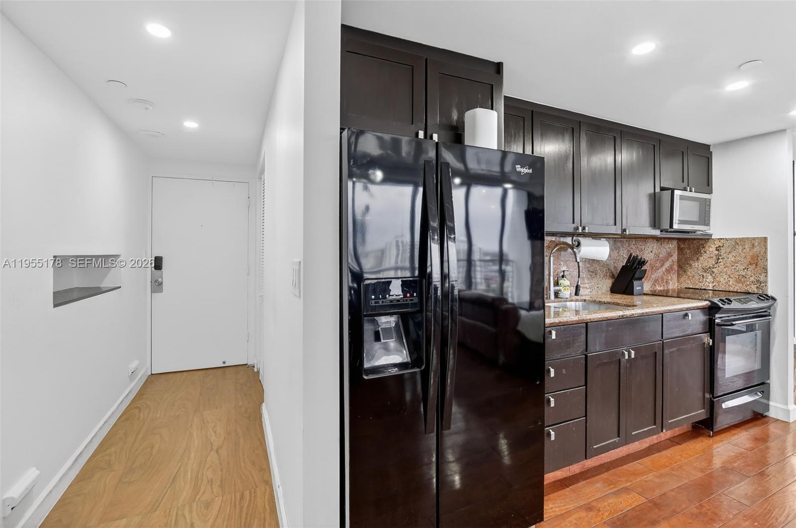 1720 Harrison Street, Unit 14H Hollywood, FL 33020 - Photo 8 of 37 a kitchen with a sink stainless steel appliances cabinets and a counter top space