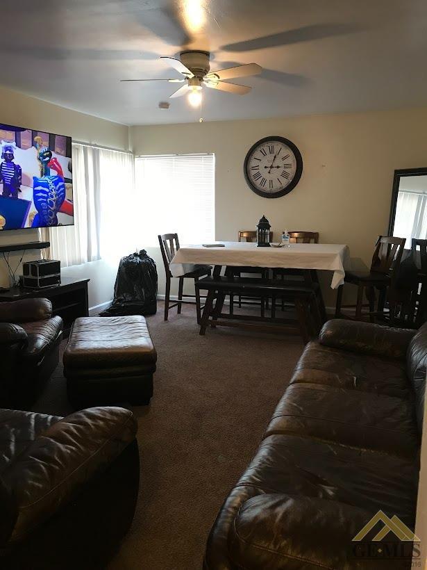 Undisclosed Address Bakersfield, CA 93305 - Photo 2 of 8 a living room with furniture a rug and a wall painting