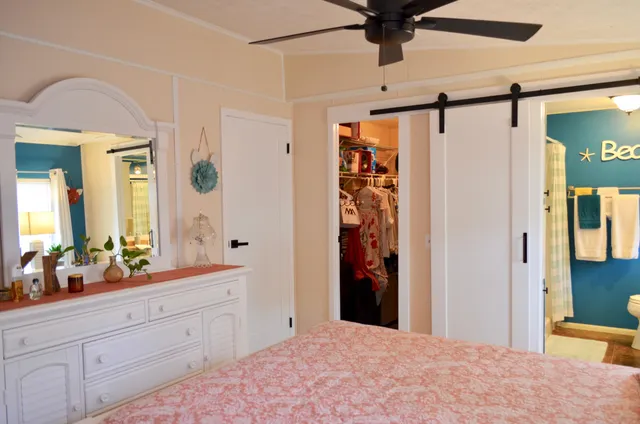 a bathroom with a granite countertop sink a toilet and shower