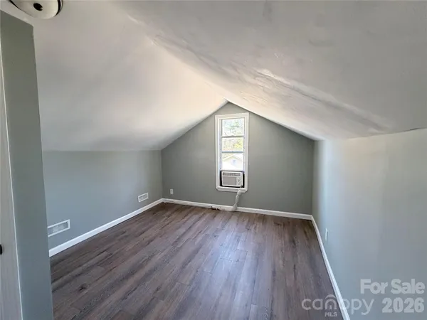 a kitchen with granite countertop a stove a sink and a microwave