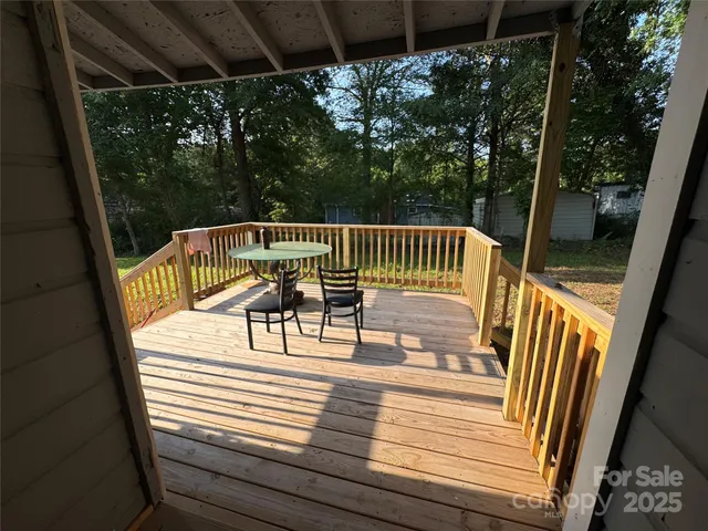 a view of balcony with wooden floor and outdoor seating