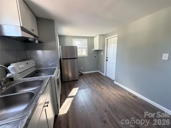 a kitchen with a refrigerator and a sink