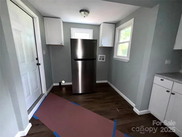 a kitchen with refrigerator and window