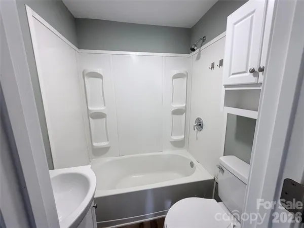 a bathroom with a toilet and a bathtub