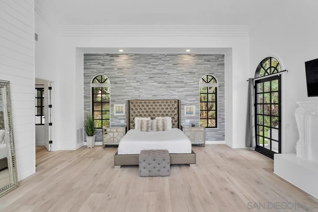 17101 Circa Oriente Rancho Santa Fe, CA 92067 - Photo 14 of 35 a spacious bedroom with a bed and a large window