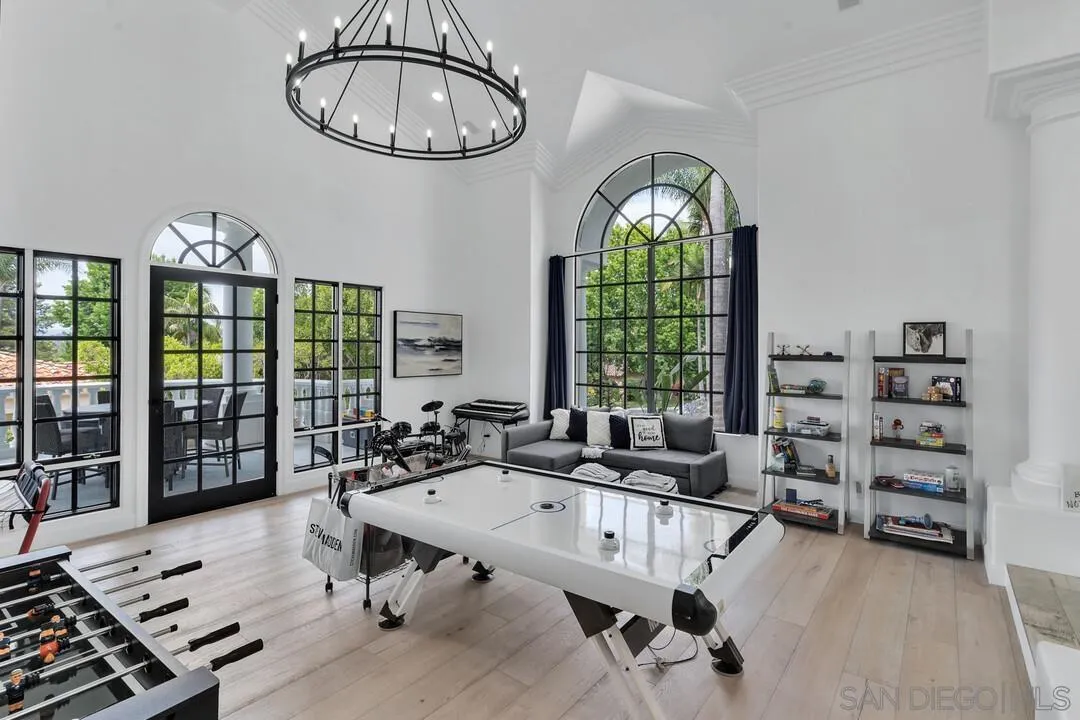 17101 Circa Oriente Rancho Santa Fe, CA 92067 - Photo 17 of 35 a living room with furniture a chandelier and a large window