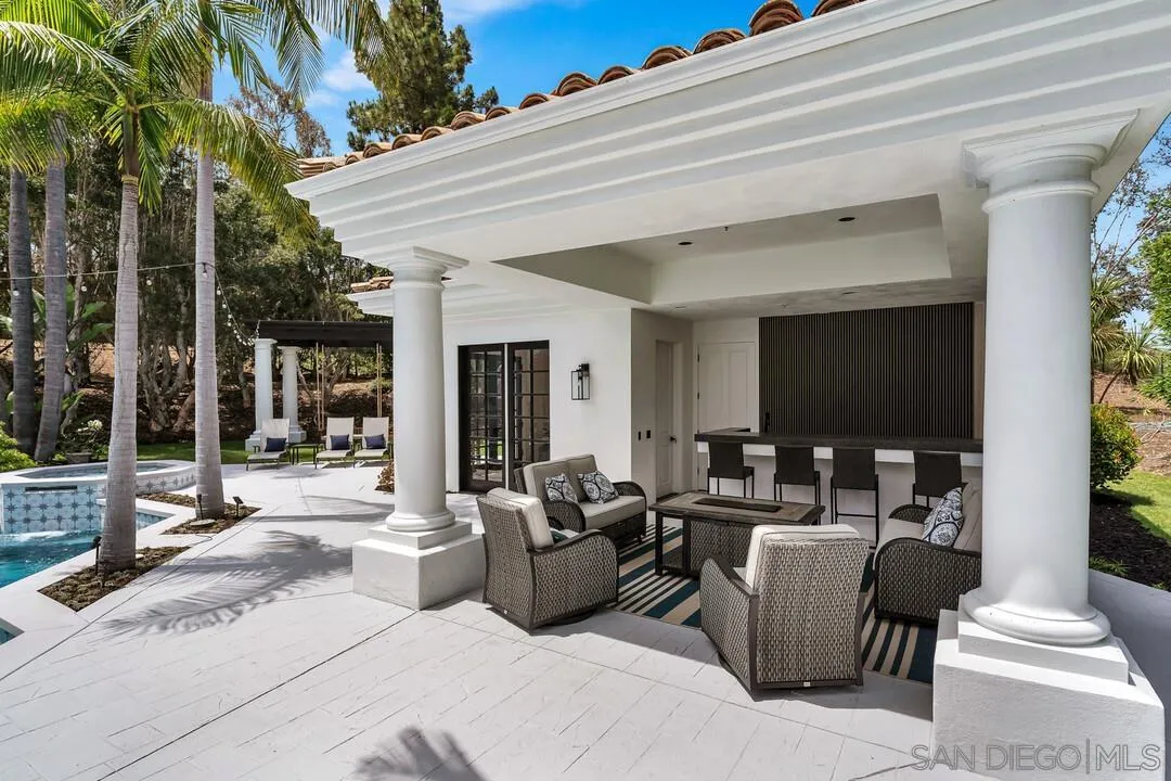 17101 Circa Oriente Rancho Santa Fe, CA 92067 - Photo 22 of 35 a view of a patio with couches table and chairs with wooden floor and fence