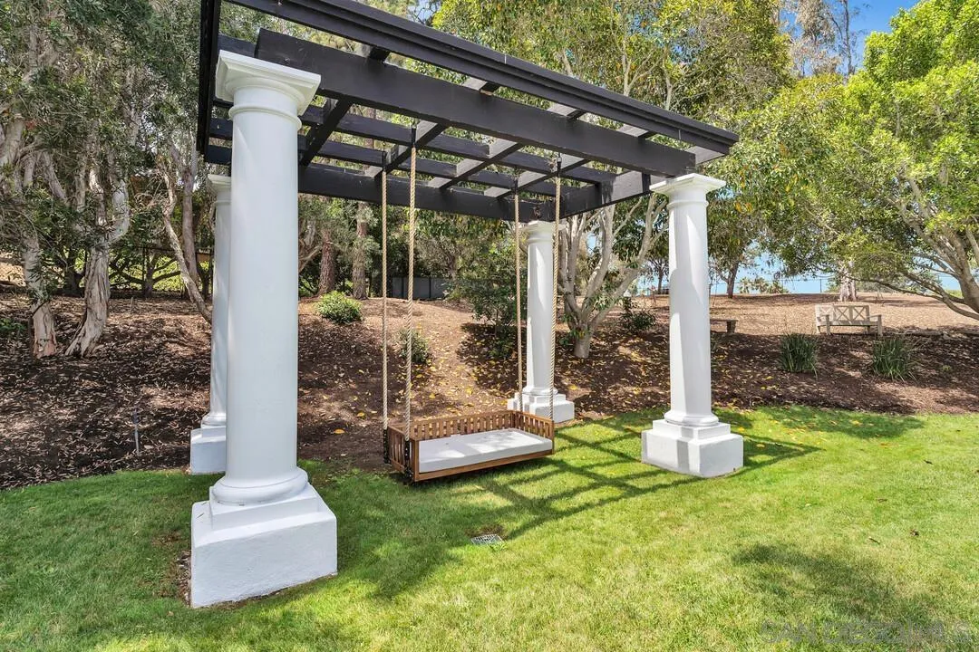 17101 Circa Oriente Rancho Santa Fe, CA 92067 - Photo 26 of 35 a view of a chair and table in backyard of the house