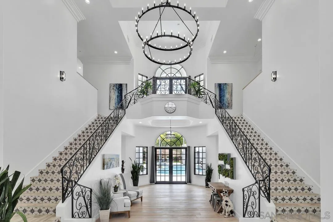 17101 Circa Oriente Rancho Santa Fe, CA 92067 - Photo 3 of 35 a view of staircase with a large window and wooden floor