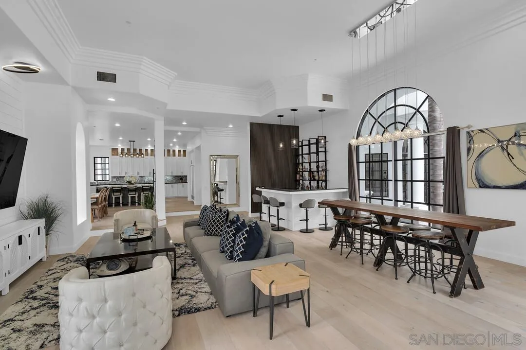 17101 Circa Oriente Rancho Santa Fe, CA 92067 - Photo 8 of 35 a living room with furniture a large window and a chandelier