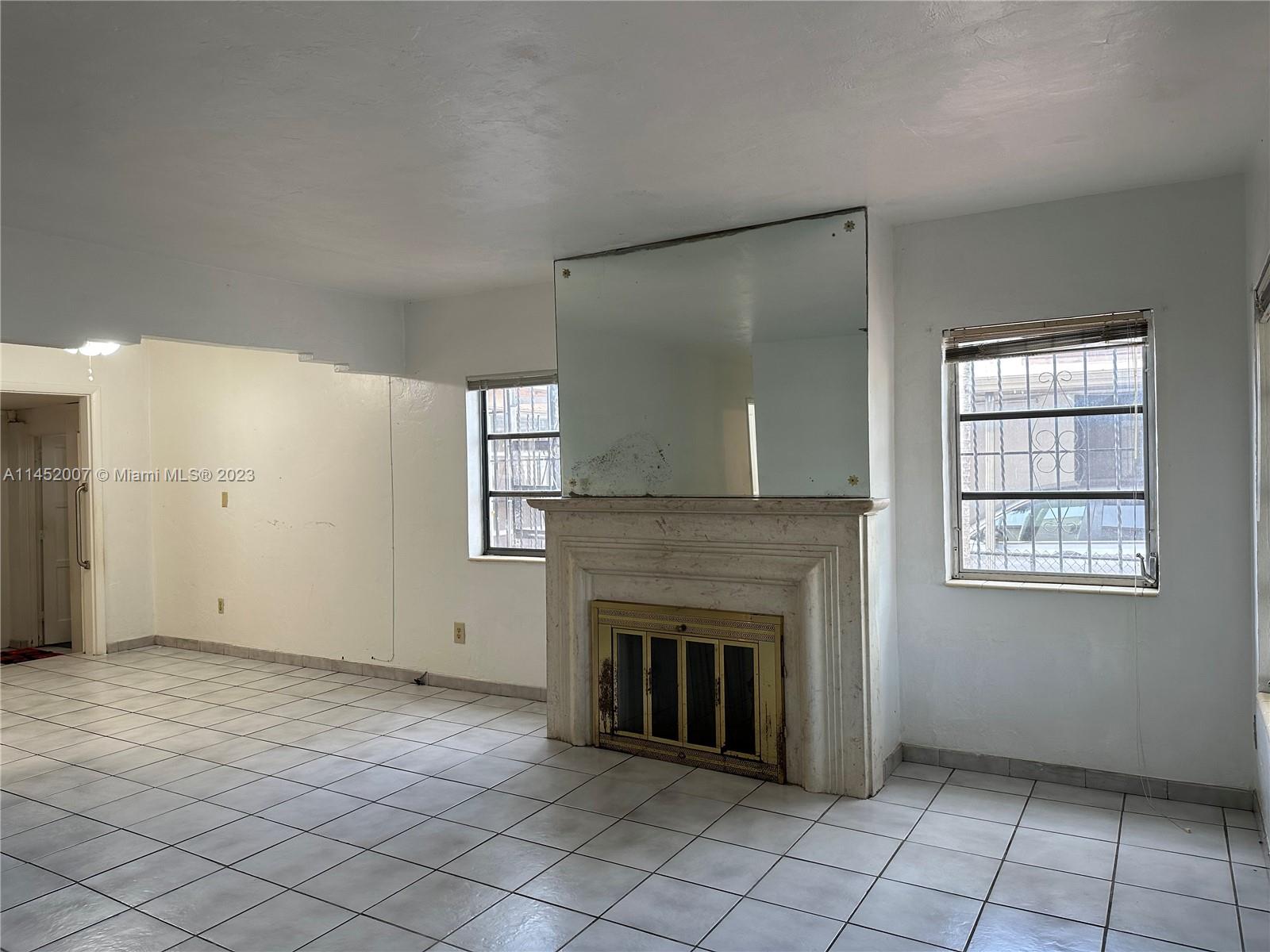 West Flagler Miami, FL 33135 - Photo 13 of 46 an empty room with windows and fireplace